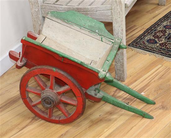 A small painted wood animal with iron spoked wheels